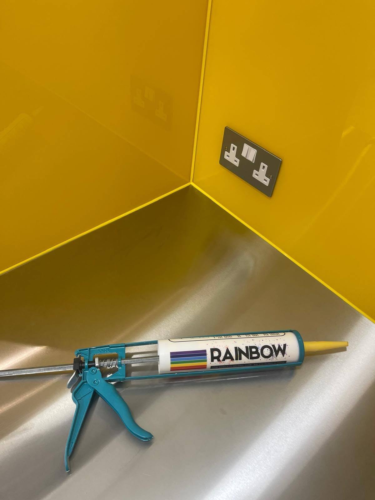 Colour-matched silicone cartridge used beside a yellow glass splashback
