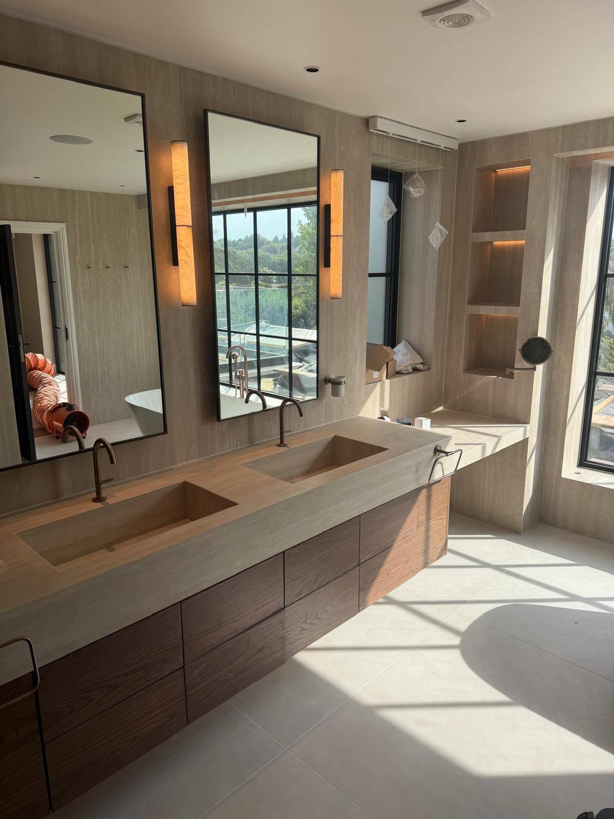 Clean white silicone sealant line along a stone double vanity top in a bathroom